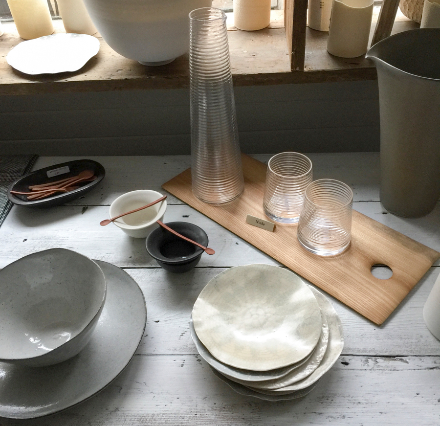 Wood cutting board by John Tildesely used as tray for ribbed glass jug by Nude Glass Poem and ceramic lace plates by Fliff Carr at Maud & Mabel 