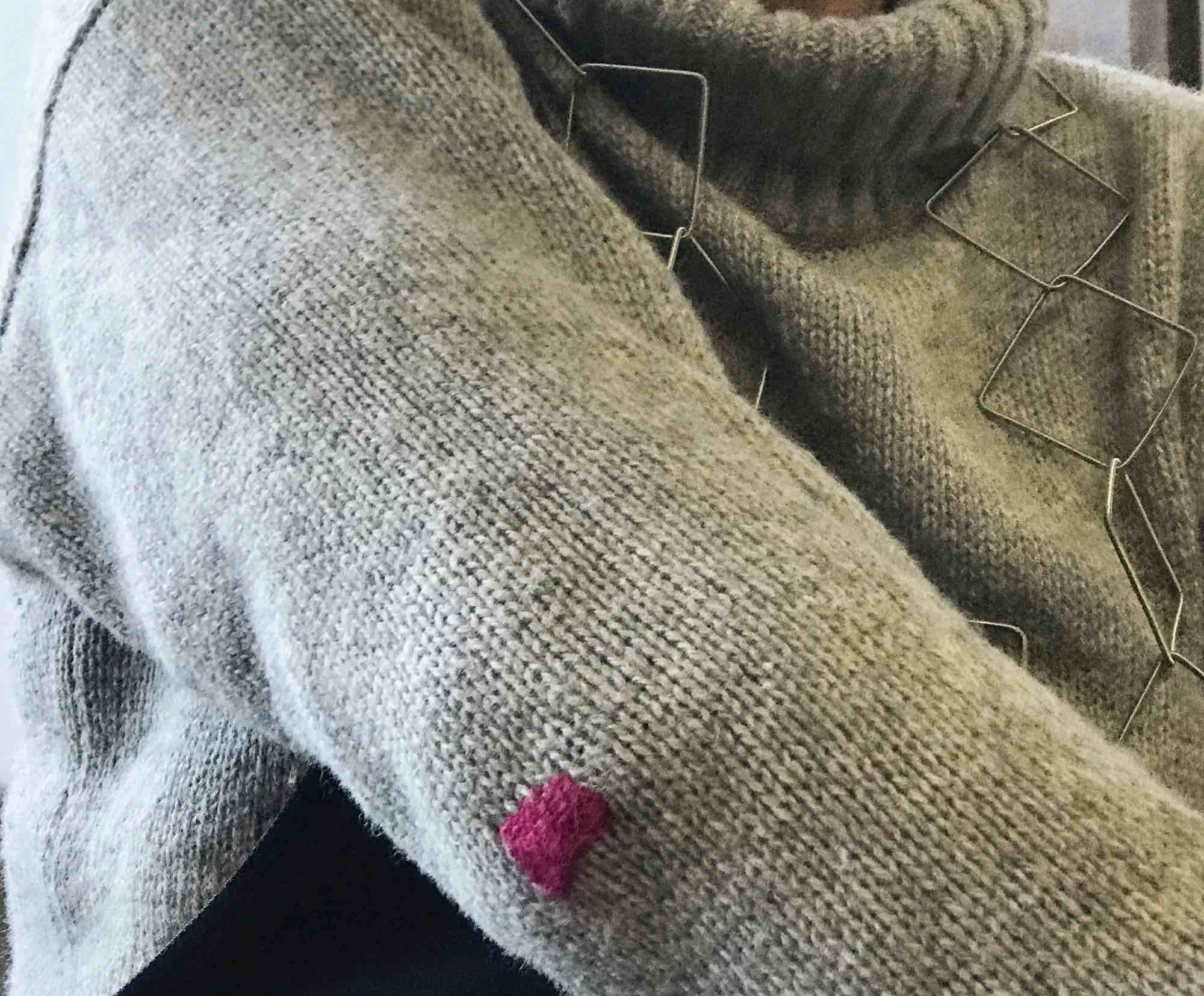 Gray sweater jumper with magenta darned patch